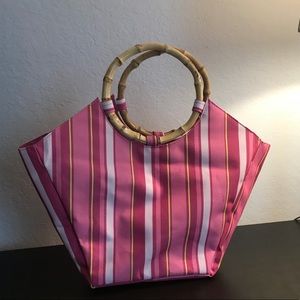 Pink striped handbag with bamboo handle.
